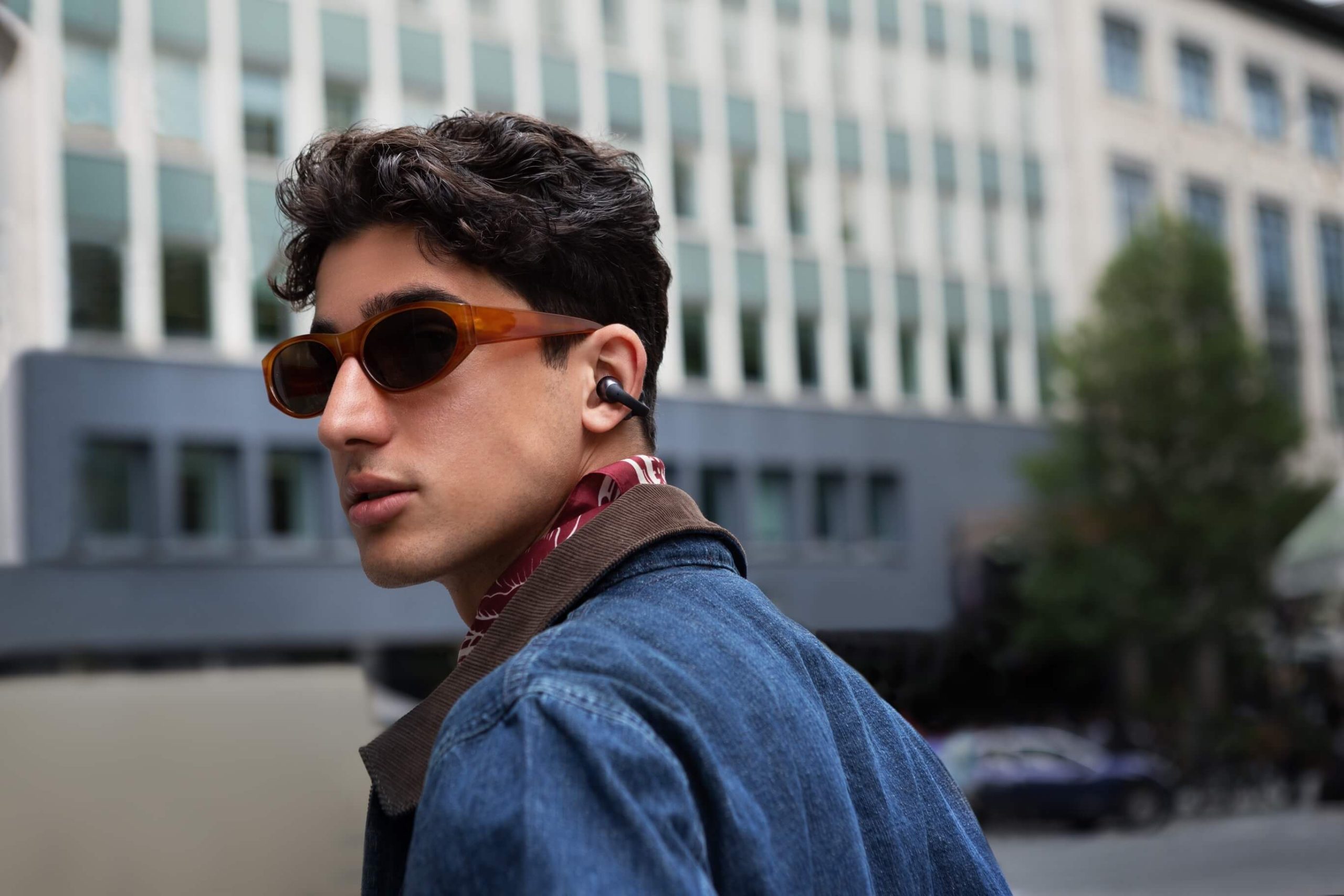 Male person wearing Shokz OpenDots ONE